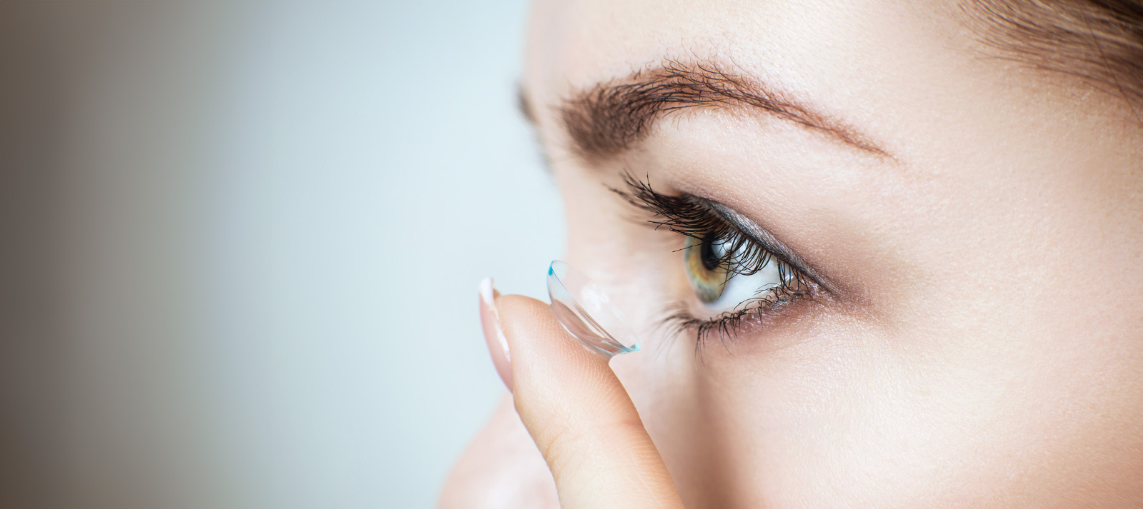 A close-up of a person s face with a focus on their eye, featuring an eyelash extension process.