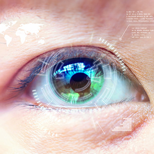 The image features a close-up view of a human eye with a digital overlay displaying various technological elements such as circuit patterns, graphs, and text, suggesting a theme related to technology, surveillance, or artificial intelligence.