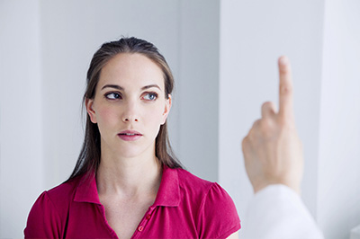 The image shows a woman looking at a man s face with a concerned expression, while he points towards her with his finger.